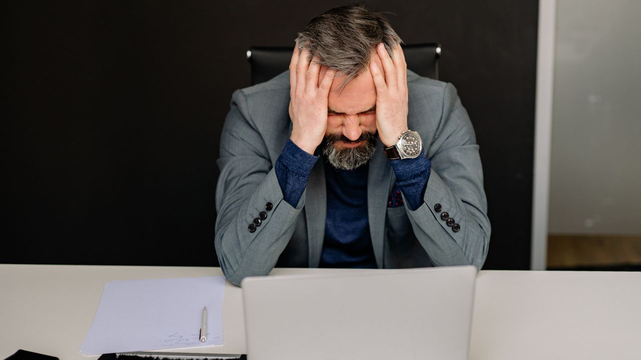 remote worker feeling stressed at laptop, working from home mental fatigue